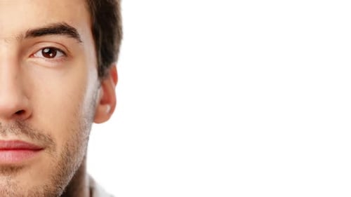 4k video footage of a young man standing against a white studio background
