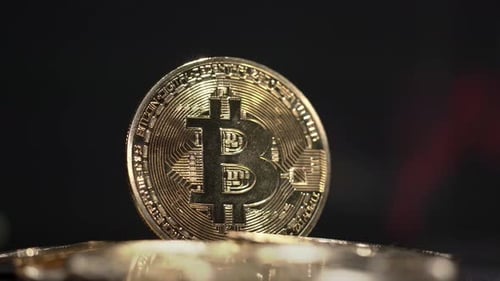 Bitcoin Coin Close Up with Cryptocurrency Chart