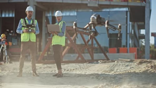 Diverse Team of Specialists Pilot Drone on Construction Site. Architectural Engineer and Safety Eng