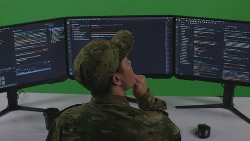 Asian Man Soldier Thinking About Something While Write Code With Multiple Screens In Green Screen