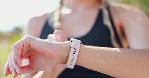 Woman Interacts with Smart Watch Outdoors