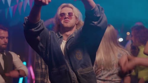 Enthusiastic people dancing and enjoying party at night