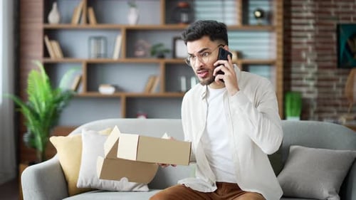 Excited Man on Phone Receiving Delivery at Home