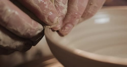 Potter in the Potter's Wheel Makes Ceramic Product Using His Hands and Pottery Tools Close Up