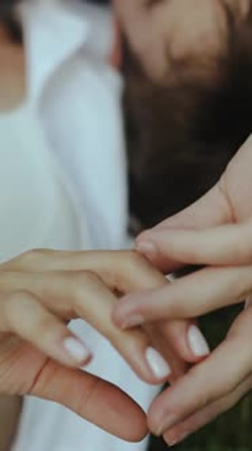 Closeup of Intertwined Fingers of Wedding Couple