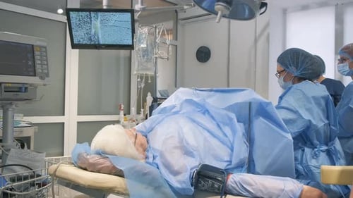 Operation in Bright Operating Room with Medical Staff