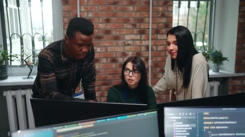 Diverse Multiethnic Coworkers in Office of ITcompany Man and Women Discussing Project of Website