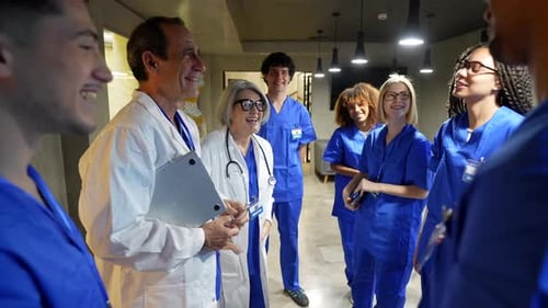 Doctors and nurses discussing a case in a hospital corridor