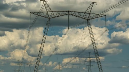 Timelapse of Clouds Moving Over High Voltage Pylons