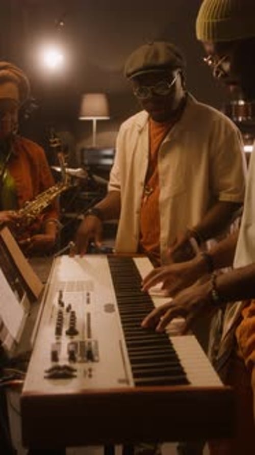 African American Music Band Trying out Chords for New Song on Keyboards