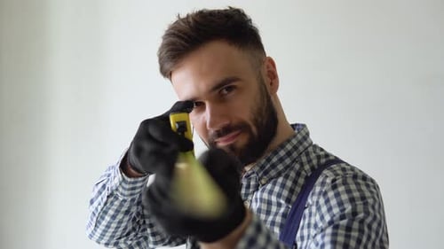 Portrait of a Man Builder with Tape Measure