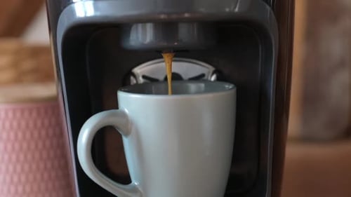 Coffee Pours into Mug from Home Coffee Maker