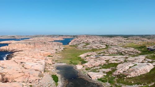 Beautiful Smooth Granite Shoreline Of Bohuslan Under Clear Blue Sky In Gotaland, Sweden. wide aerial