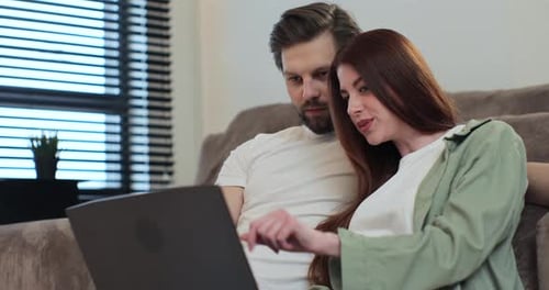 Couple Uses Laptop Together at Home