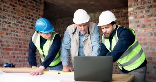 Discussion, laptop and construction workers on site for planning building, repairs or maintenance
