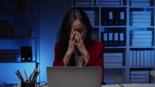 Businesswoman seriously stressed working overtime headache and eye ache due to office syndrome