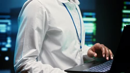 African American Programmer Checking Server Rigs for Data Center Maintenance