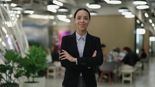 Portrait of the Professional Business Woman Standing in Office Amidst a Working Team with Crossed