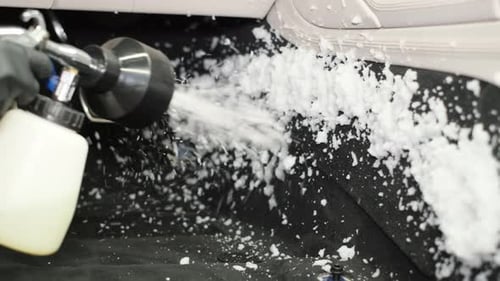 Spraying the Car with White Foam