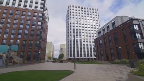 Flower Beds with Greenery Stand in Paved Walkway Area FPV