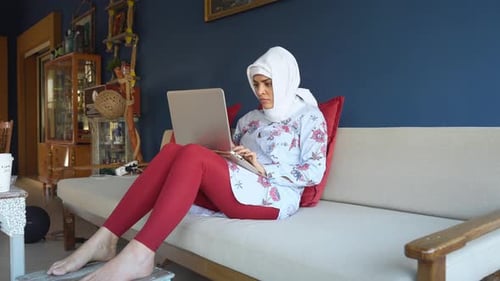 Beautiful Happy Muslim Arabic Woman Using Laptop Remote Work Home Office Indoors Female In Hijab