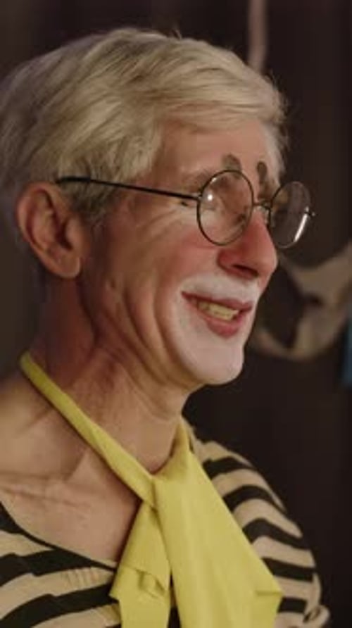 Adult Clown Puts on Glasses and Smiles