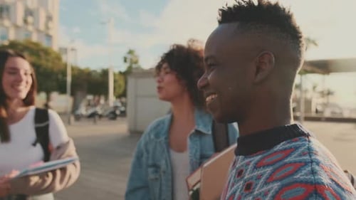 Young Adults Smiling Together Holding Notebooks on Campus