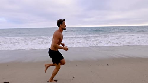 Athletic Man Exercising At The Beach
