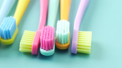 Colorful Toothbrushes on Blue Background for Dental Health