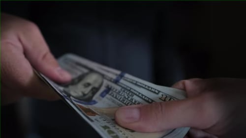 Close Up of Hands Counting Stack of Money