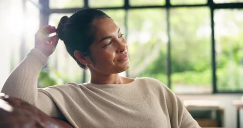 Woman Relaxing on Couch with Hand Behind Head