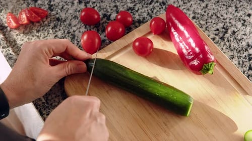 Top Down View Female Hands Cut Green Fresh Cucumber on Board Closeup