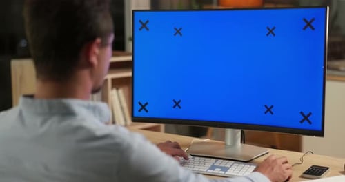 Green screen, computer and man in office online for website, research and internet working at night