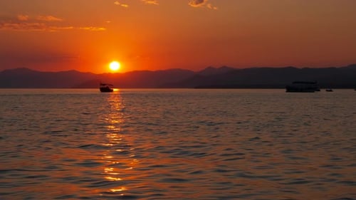 Golden Sunset Over Ocean with Boats