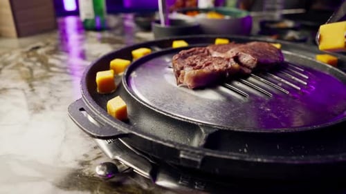 close up of delicious appetizing juicy piece of grilled meat with cheese being fried in restaurant