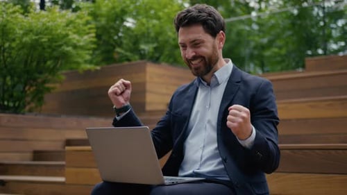 Happy Caucasian Businessman Celebrate Good News Working Laptop Outdoors in City Man Joyful Male