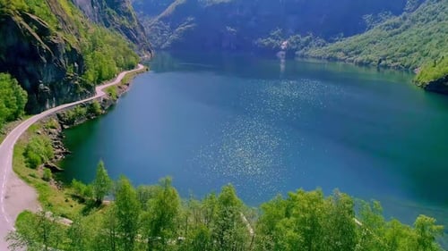 Drone dolley tilt shot of sunlight reflected in the calm Aurlandsfjord in Norway