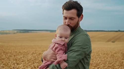 Father Farmer Holds His Daughter in Arms in Wheat Field Family Reaches Out to Sun Happy Family