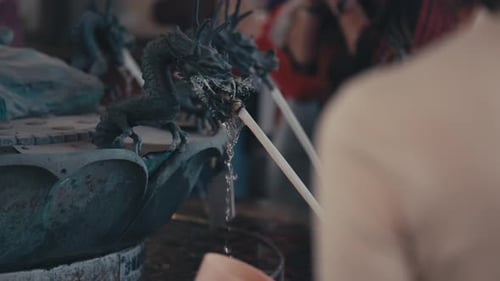 Closeup Of Black Dragon Fountain With People In Tokyo, Japan. slow motion