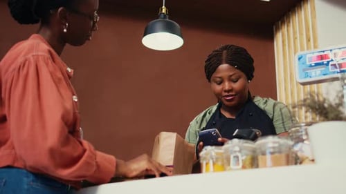 Consumer Making Card Payment at Organic Shop Checkout