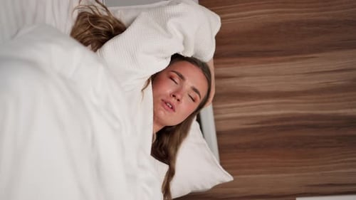 Vertical Video Close Up in Modern Clinic in a Bright VIP Room Lies Young Girl in a White Coat with a