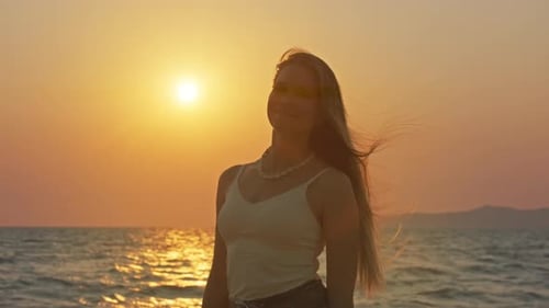 Young Woman Enjoying Sunset at Beach