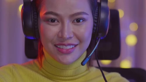 Enthusiastic Young Woman Smiling with Gaming Headset