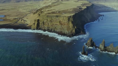 Bird's Eye View Of Cliffs And Reynisdrangar Rock Formations At Reynisfjara Black Sand Beach In South