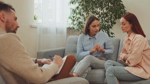 Two Women Talking with Therapist in Bright Office