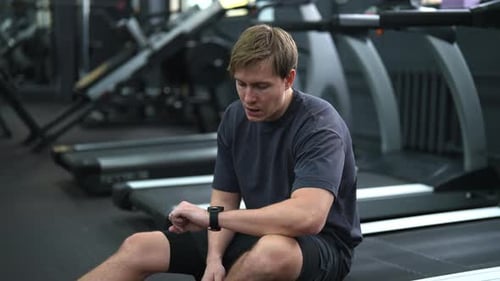 Tired Beginner Sportsman Taking Break at Sport Gym Sit on Treadmill Portrait of Exhausted Sweaty