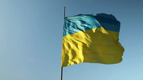Ukrainian Flag Waving Against Blue Sky