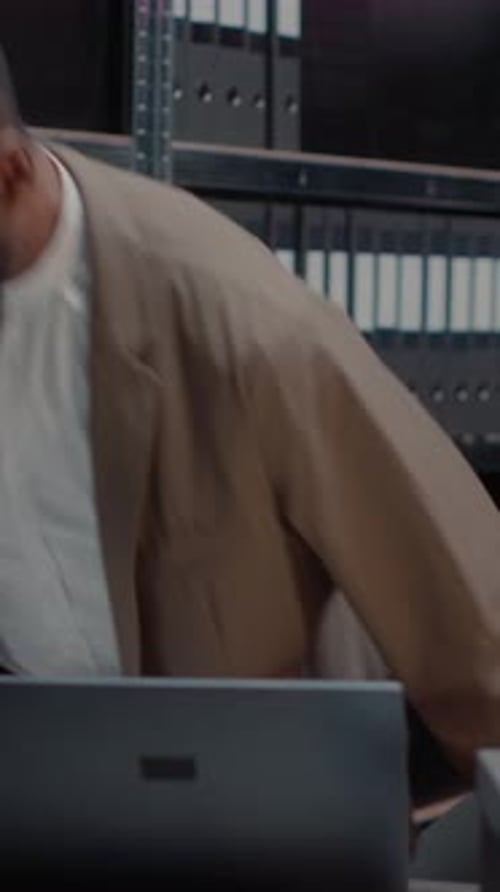 Adult Working on Laptop in an Urban Office