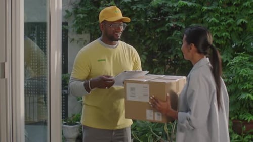 Woman Receiving Parcel from Delivery Man at Home