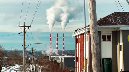 Tall Chimneys of a Coalfired Power Plant with Black Smoke Rising Up
